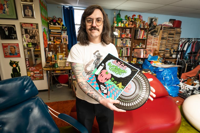 Perry Shall in his studio with the album cover design for which he was nominated for a Grammy. Shall does all the artwork design for Easy Eye Sound, the Nashville record label owned by Dan Auerbach of the Black Keys.