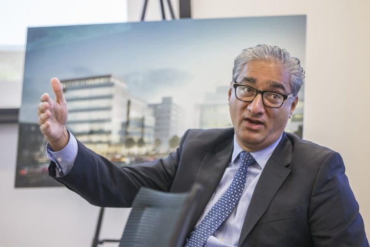 With renderings of Camden development projects behind him, Kris Kolluri, incoming CEO of the city’s Cooper’s Ferry Partnership, talks to officials of the Waterfront Ventures group about the need to put Camden’s “best face” online.