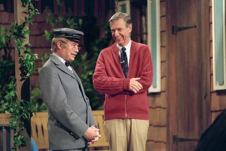 Fred Rogers and David Newell, as Speedy Delivery's Mr. McFeely, stand on the front porch set while filming an episode of "Mister Rogers' Neighborhood."