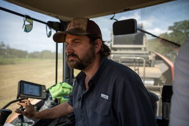 Patrick Williams harvests hay in Centerville, Texas. He and his brother Stephen are concerned about the environmental and economic impacts data centers will have on the area.
