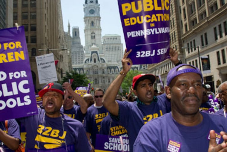 Members of the service Employees International Union Local 32BJ joined other blue collar union members of the School District of Philadelphia in a noon protest march up N. Broad St. to the School Administration Building Wednesday, May 23, 2012 where a rally was held. When members were denied entrance to the Administration Building they marched back down N. Broad St where 14 protesters staged a sit-in at the intersection of Broad and Race St and were later arrested. ( Clem Murray / Staff Photographer )