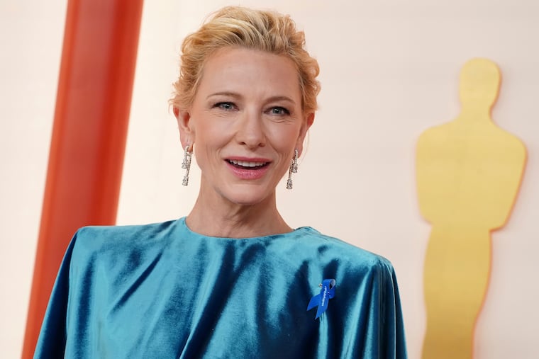 Cate Blanchett arrives at the Oscars wearing a blue ribbon on Sunday at the Dolby Theatre in Los Angeles.