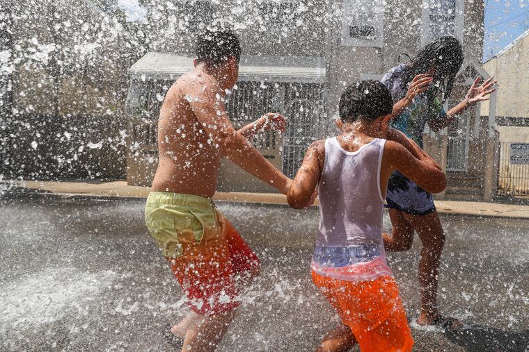 An open fire hydrant near Philadelphia's Norris Square section helped children cool off during an excessive heat warning on Aug. 9, 2022.