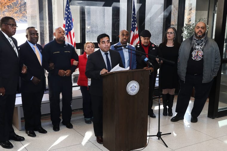 Community organizer Cristian Moreno-Rodriguez takes the podium at a news conference in Atlantic City as activists and community leaders call for action to protect immigrants.
