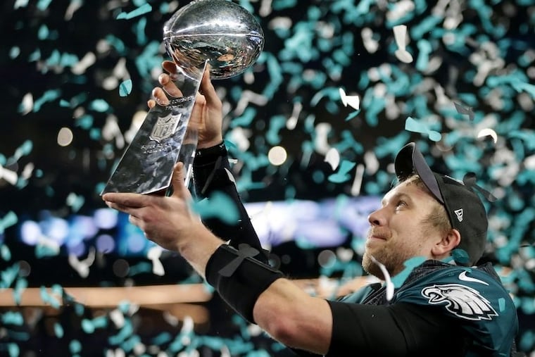 Nick Foles admires the Lombardi Trophy after he passed for 373 yards and three touchdowns in an MVP performance.
