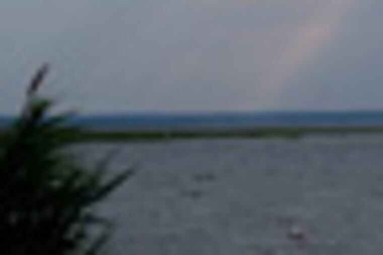 In this photograph taken Saturday June 25, 2011, sunlight streams through the clouds over Barnegat Bay. New Jersey environmental officials are in the midst of a 10-point plan to improve the health of the fragile waterway, which is threatened by pollution. Stormwater runoff from lawns and overflowing sewer systems are a major culprit. (AP Photo/Wayne Parry)