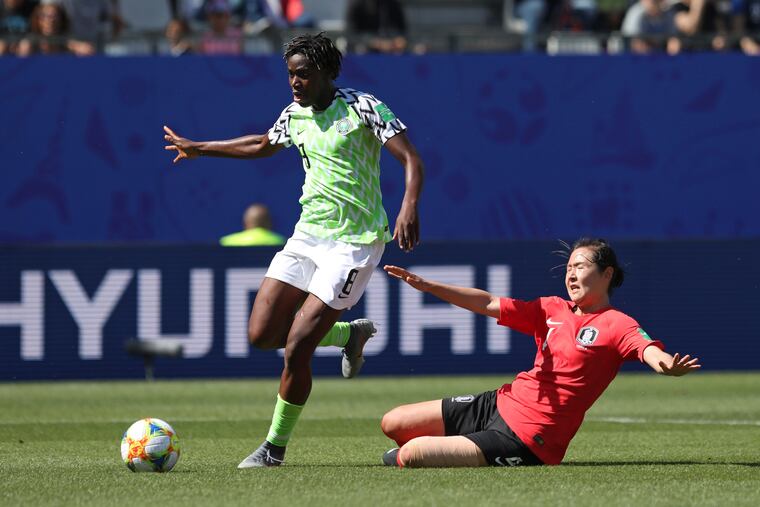 Nigeria's Asisat Oshoala gets away from South Korea's Hwang Bo-ram on her way to scoring her side's second goal.
