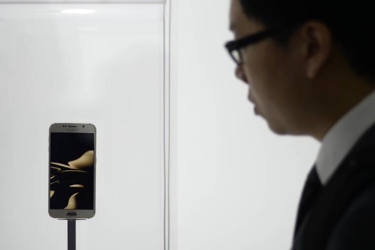 A visitor looks at the new Galaxy S6 during the Mobile World Congress, the world's largest mobile phone trade show in Barcelona, Spain, Monday, March 2, 2015. (AP Photo/Manu Fernandez)
