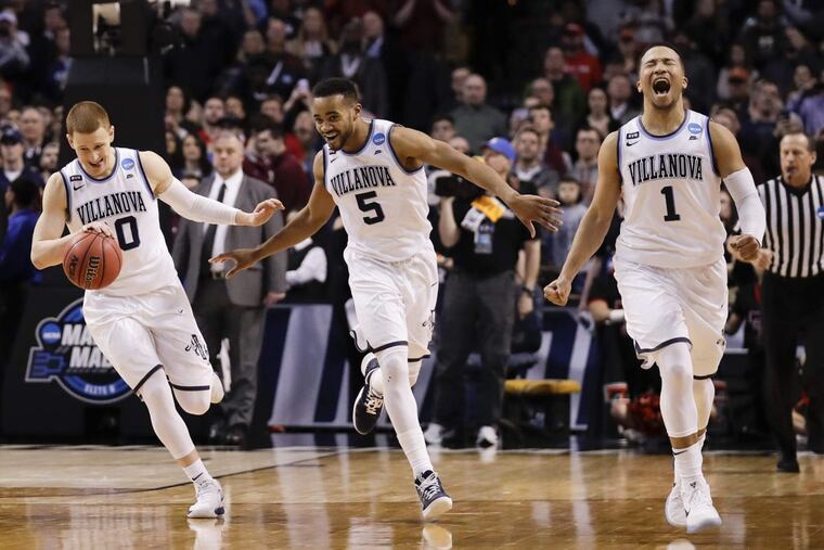 Villanova guard Donte DiVincenzo, guard Phil Booth and guard Jalen Brunson celebrate.