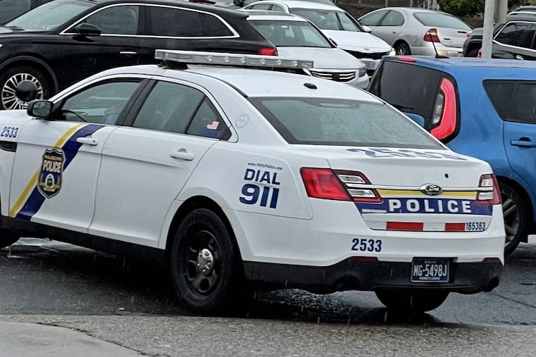 A store employee took this picture of the departing police car after an officer allegedly shoplifted at the store on Friday.