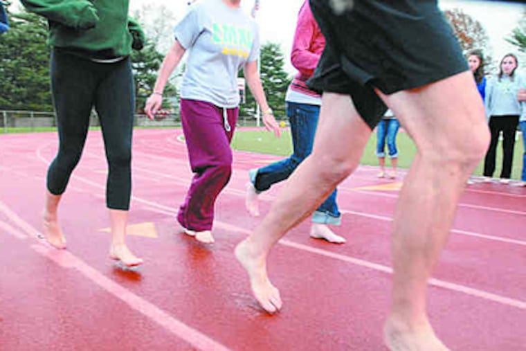 Leading the charge, Christopher McDougall and girls from Lower Merion High take a test run. (Ron Tarver / Staff)