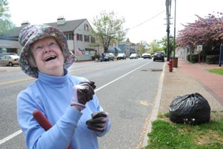 Medford Township resident Jeanette Johnson works with other members of the Pinelands Garden Club to prepare Main Street for Earth Day. "It wasn't an easy decision to make, that's for sure," says Johnson. "But we want to bring Medford back to being the community we all know and love." APRIL SAUL / Staff Photographer