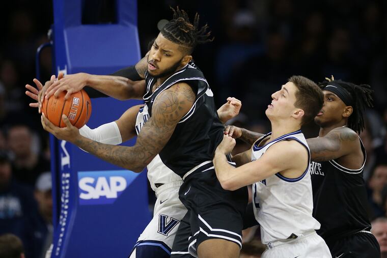 Providence center Nate Watson grabs a rebound in front of Villanova guard Collin Gillespie.