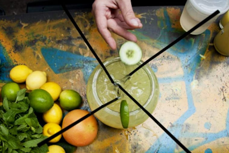 Michael Wirzenberger, managing partner at Sampan Philly, mixes a scorpion bowl of cucumber margarita at the restaurant's Graffiti Bar. Wirzenberger came up with the recipe. ( Abi Reimold / Staff Photographer )