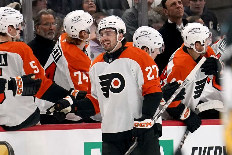 The Flyers' Noah Cates (27) returns to the bench after scoring during the second period of an NHL hockey game against the Pittsburgh Penguins Monday, Dec. 23, 2024, in Pittsburgh. (AP Photo/Matt Freed)