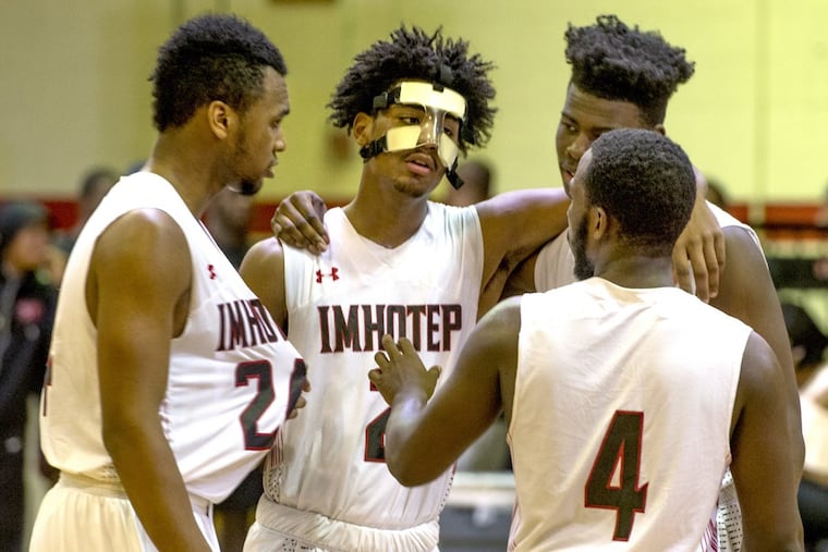 Imhotep’s Chereef Knox (center) is congratulated by teammates after he is fouled in the final seconds of their Public League boys semifinal against Mastery North.