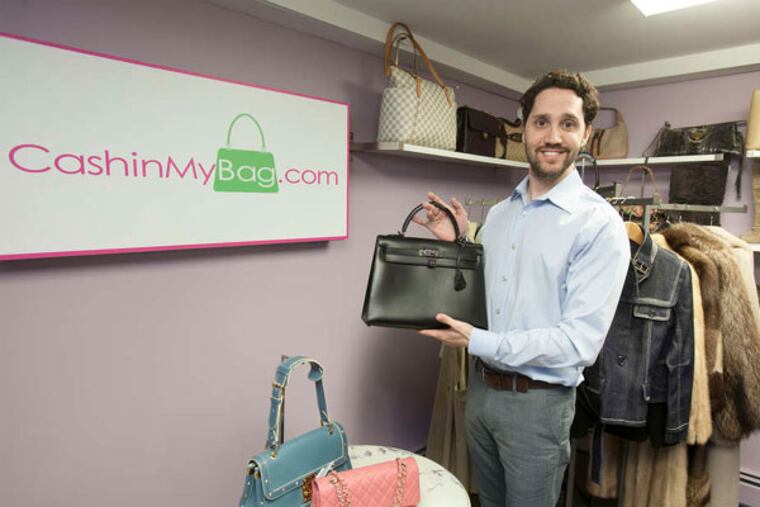 Company owner Michael Zakroff with a Hermes "Kelly Bag." He doesn't use the consignment model, but buys outright: "It's so easy to sell." (Ed Hille / Staff Photographer)