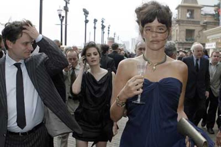 "Boardwalk Empire" cast members Shea Whigham (left), Aleksa Palladino, Paz de la Huerta and Dabney Coleman (back right) walking on the boardwalk. (Akira Suwa / Staff Photographer)