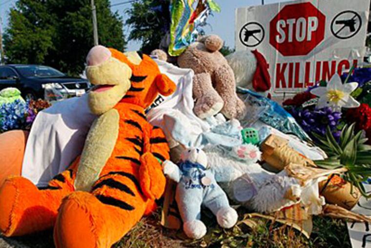 A makeshift memorial for Trayvon Martin is displayed Thursday, April 12, 2012, on the sidewalk outside the complex where Martin was shot dead by neighborhood watch volunteer George Zimmerman in Sanford, Fla. (AP Photo/Chris O'Meara)