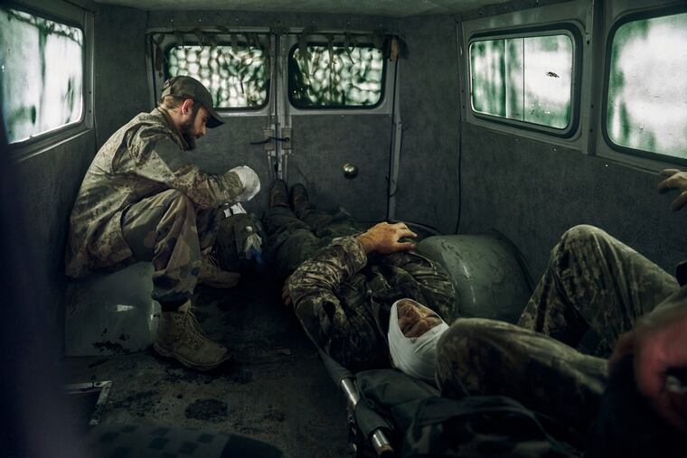 Wounded Ukrainian soldiers inside a vehicle in the freed territory of the Kharkiv region in Ukraine on Monday