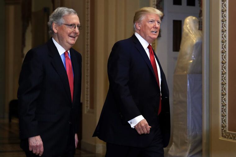 President Donald Trump and Senate Majority Leader Mitch McConnell of Ky., walk on the hallways of the U.S. Capitol on Tuesday.
