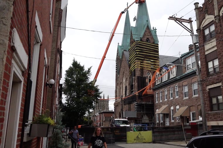 This image from an Inquirer video shows the start of demolition of the twin spires of St. Laurentius Church in Fishtown in mid-August.