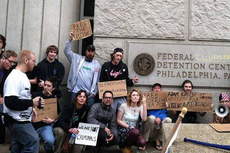Protesters demonstrate yesterday outside the Federal Detention Center, where they say two men are being held. (Jason Nark/Staff)