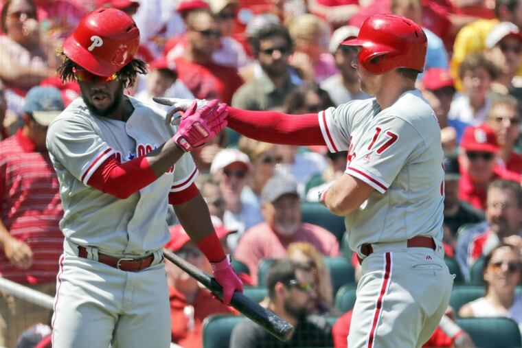Odubel Herrera congratulates teammate Rhys Hoskins after Hoskins scored the Phillies’ only run Sunday.