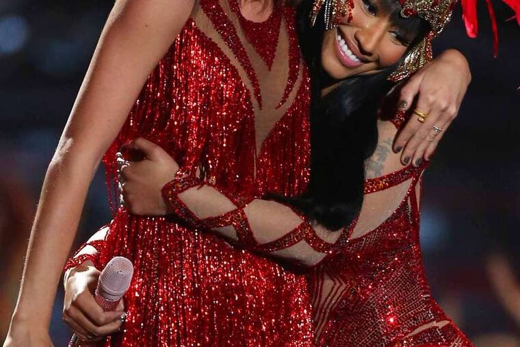 Taylor Swift (left) and Nicki Minaj "make up" at the "VMAs" Sunday after a feud on Twitter.
