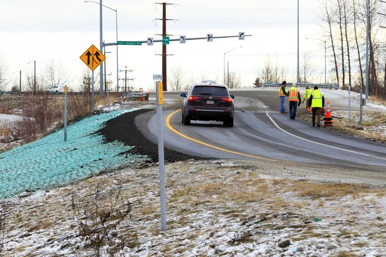 A car ascends a newly repaired off-ramp of Minnesota Drive on Wednesday, Dec. 5, 2018, in Anchorage, Alaska. A massive 7.0 earthquake and its aftershocks rocked buildings and buckled roads Nov. 30, including the road that's a route to Ted Stevens Anchorage International Airport. Alaska transportation officials made rebuilding the ramp a priority. It reopened Tuesday, Dec. 4, and a crew completed shoulder work Wednesday. (AP Photo/Dan Joling)
