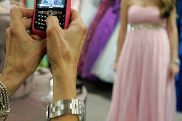 File photo: A girl poses in a prom dress for a photo.