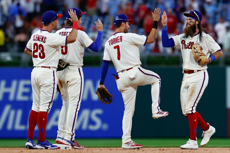 Phillies center fielder Brandon Marsh, shortstop Trea Turner, second baseman Bryson Stott and first baseman Kody Clemens celebrate their 7-6 win over the New York Mets on Sunday, June 25, 2023 in Philadelphia.