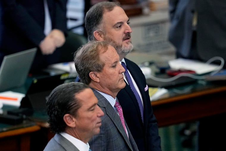 Texas Attorney General Ken Paxton (center) stands with attorneys Tony Buzbee (front) and Mitch Little during his impeachment trial Friday.,