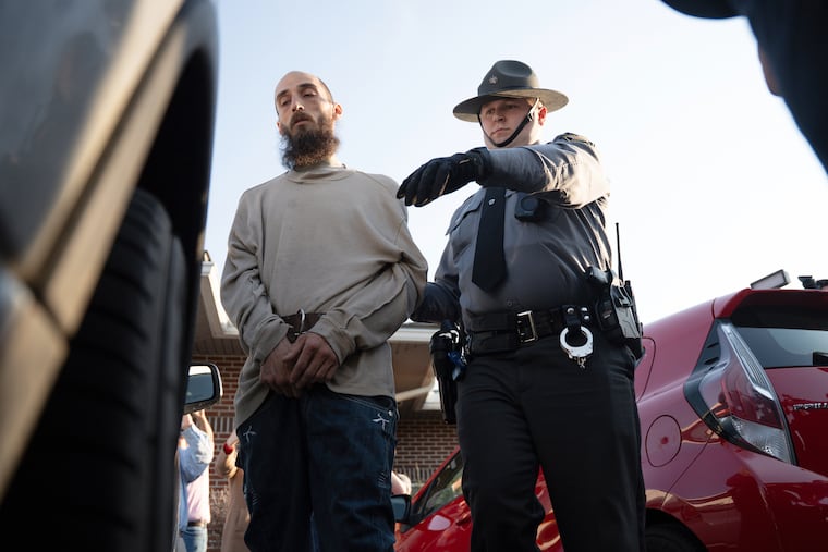 Cody Balmer is escorted from court after his preliminary arraignment on April 14 in Harrisburg.