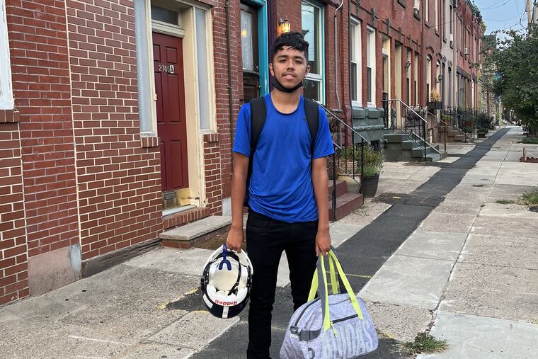 Nicolas Elizalde, 14, waiting for the bus before his first day of ninth grade at Walter B. Saul High School.