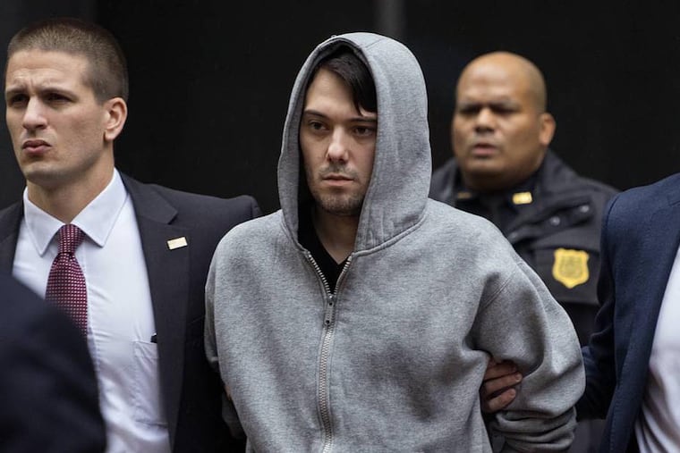 Martin Shkreli, the former hedge fund manager under fire for buying a pharmaceutical company and ratcheting up the price of a life-saving drug, is escorted by law enforcement agents in New York Thursday, Dec. 17, 2015, after being taken into custody following a securities probe. A seven-count indictment unsealed in Brooklyn federal court Thursday charged Shkreli with conspiracy to commit securities fraud, conspiracy to commit wire fraud and securities fraud.