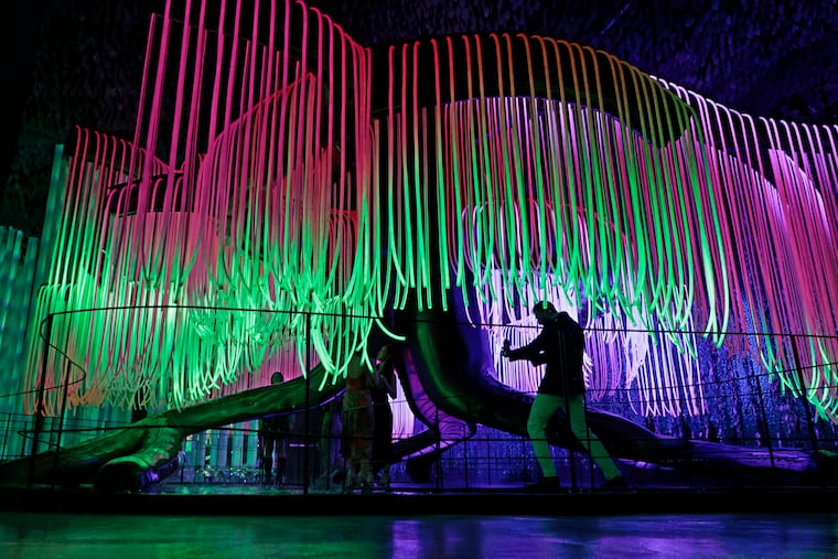 Guests take photos under the “Weeping Willow” at the VIP preview of Otherworld, 2500 Grant Ave. in Phila., Pa. on Thursday, August 3, 2023.