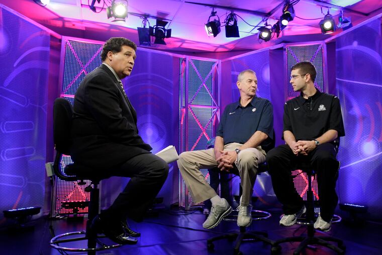 Greg Gumbel (left) watches as Connecticut head coach Jim Calhoun talks to Butler head coach Brad Stevens, right, prior to taping a television interview for the men's college basketball 2011 NCAA Final Four.