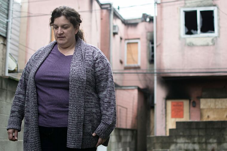 Joyce Crocker in the back lot at 2544 S. Reese St., a house that caught fire Nov. 9. The house had been vacant since its owner died, and drug dealers had moved in. Three families were displaced by the fire.