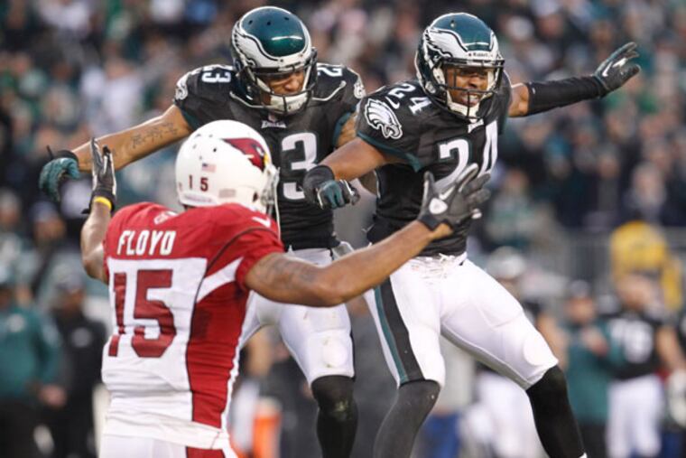 Bradley Fletcher celebrates with teammate Patrick Chung after Fletcher knocked the ball away from the Cardinals' Michael Floyd. (Ron Cortes/Staff Photographer)