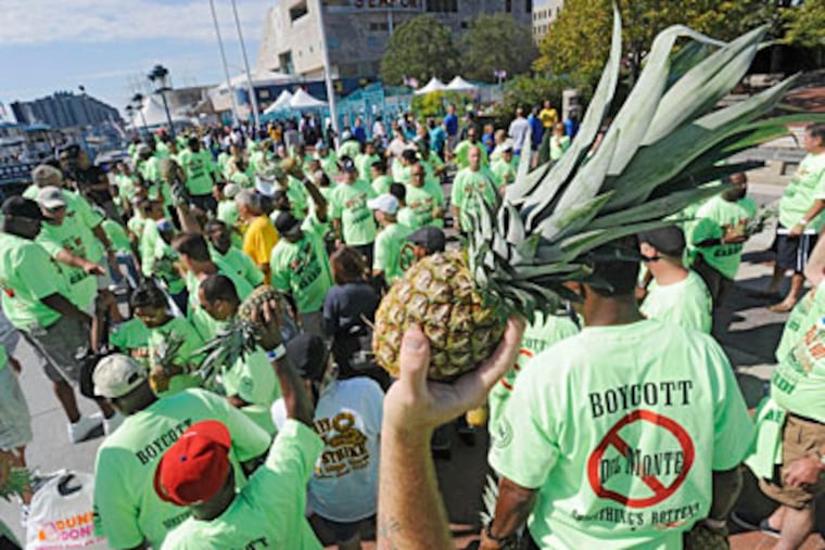 The International Longshoremen's local union protests Del Monte by throwing pineapples into the Delaware River. ( Clem Murray / Staff Photographer )