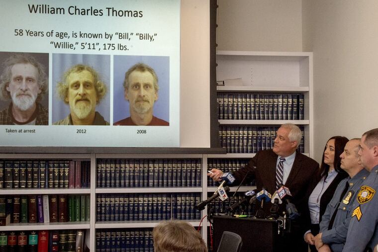 Bucks County District Attorney Matthew Weintraub (striped tie) shows photos during a February 6, 2017 press conference on William Charles Thomas, 58, of Falls Township, charged with multiple counts of child sexual assault over the course of 40 years.