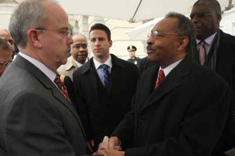 Roland Burris saying goodbye to Senate Sergeant at Arms Terry Gainer outside the Capitol in Washington yesterday.