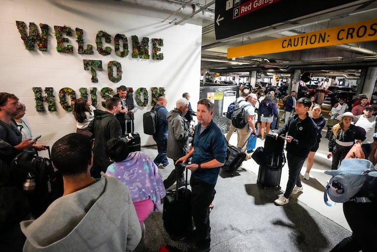 Airline passengers wait in long lines outside the terminal to get through the TSA security screening at William P. Hobby Airport in Houston, Sunday, March 8, 2026.