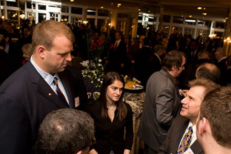 Former Eagle Jon Runyan presses the flesh at the Camden County Republican's Lincoln Day dinner. Runyan, considered the strongest candidate for the 3rd congressional seat, listens to fellow Republicans voice their issues and concerns. (Ed Hille / Staff Photographer)