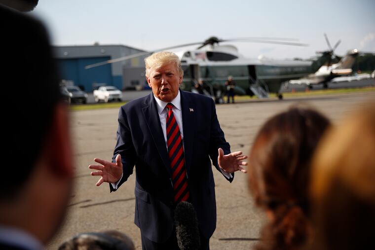 President Donald Trump speaks with reporters before boarding Air Force One at Morristown Municipal Airport in Morristown, N.J., Sunday, Aug. 18, 2019.