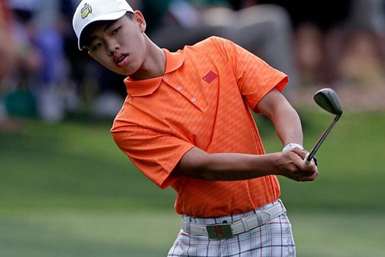 Amateur Guan Tianlang, of China, chips to the first green during the second round of the Masters golf tournament Friday, April 12, 2013, in Augusta, Ga. (AP Photo/Darron Cummings)