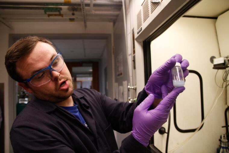 University of Pennsylvania Ph.D. student Bren Cole demonstrates a process for separating rare earth metals, used to make smartphones, TVs, and wind turbines.