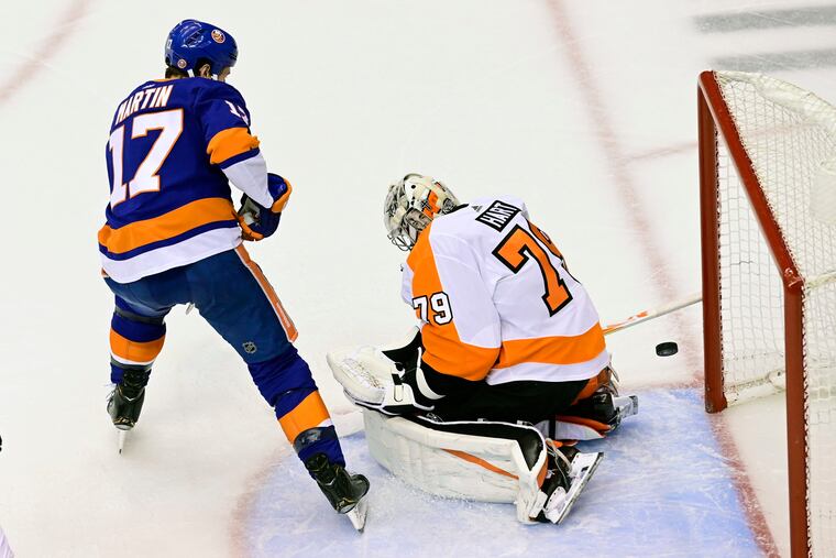Islanders winger Matt Martin slips the puck past Flyers goaltender Carter Hart in the second period to tie Game 3, 1-1. The Islanders went on to score two more unanswered to win, 3-1, and take a 2-1 series lead. (Frank Gunn / The Canadian Press via AP)