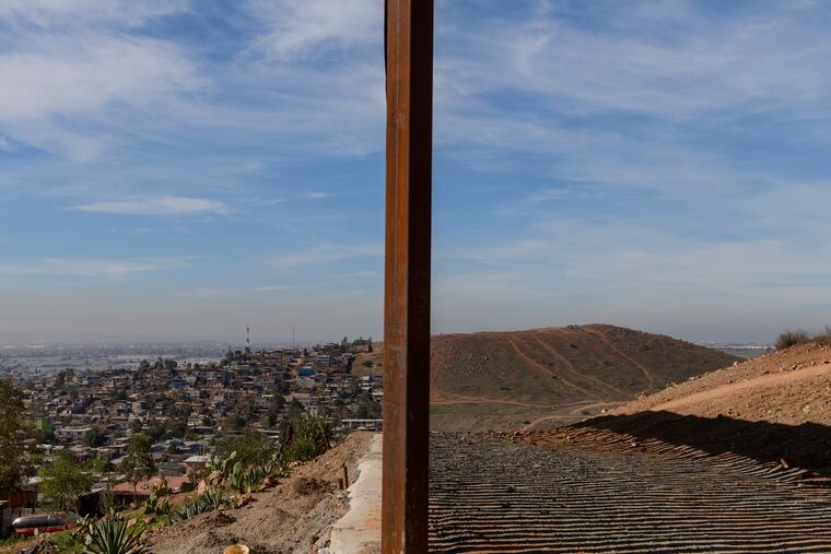 FILE - This Saturday, Dec. 22, 2018 file photo shows Tijuana, Mexico, left, and San Diego, Calif., separated by a U.S. border fence. The partial government shutdown which started in December 2018 has furloughed hundreds of thousands of government employees and halted services that aren’t deemed essential, including, in many instances, the immigration courts overseen by the Justice Department. (AP Photo/Daniel Ochoa de Olza)